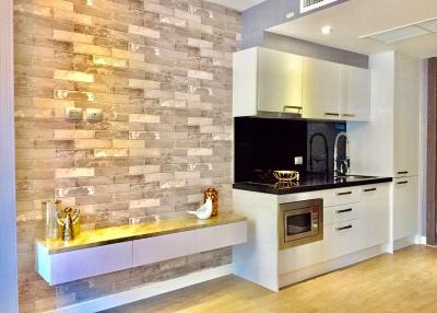 Modern kitchen with brick accent wall and built-in appliances