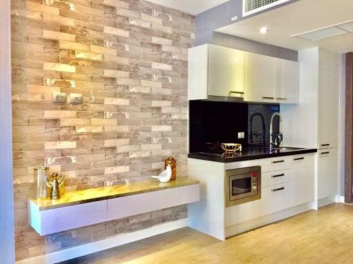 Modern kitchen with brick accent wall and built-in appliances