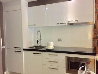 Modern kitchen with black countertops and white cabinetry