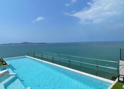 Infinity pool with ocean view and clear skies