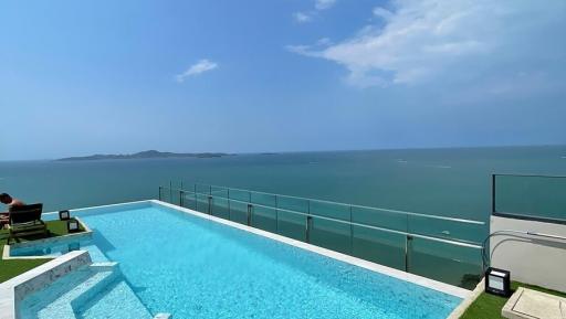 Infinity pool with ocean view and clear skies