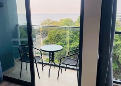 Cozy balcony with a sea view, chairs and a table