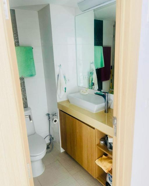 Modern bathroom with bright lighting and wooden vanity