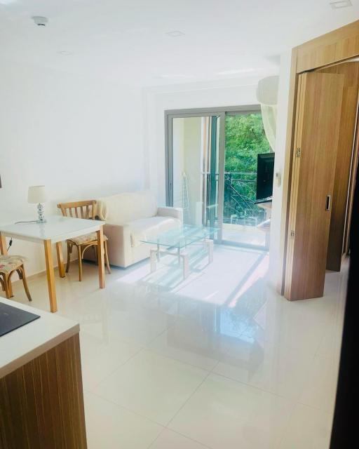 Bright and modern living room with open glass door leading to outdoor area