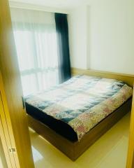 Cozy bedroom with natural lighting and a double bed