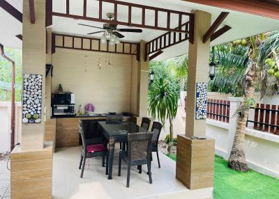 Stylish covered outdoor patio with dining set and kitchenette