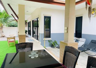 Spacious covered patio area with outdoor furniture