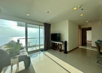 Bright and spacious living room with ocean view and balcony access