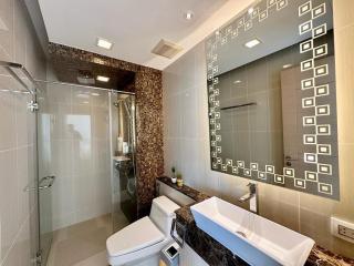 Modern bathroom interior with glass shower area and decorative tiles