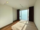 Spacious bedroom with large window and sea view