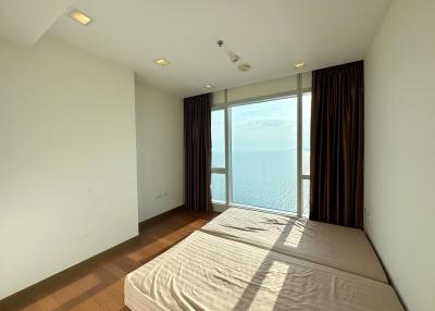 Spacious bedroom with large window and sea view