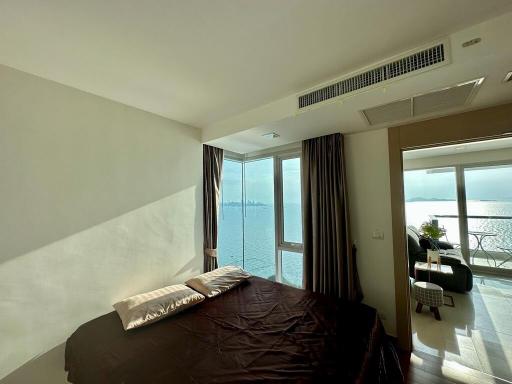 Cozy bedroom with ocean view and balcony access