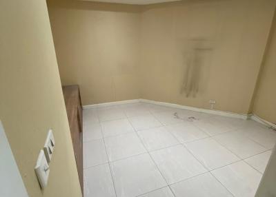 Empty room with beige walls and tiled flooring