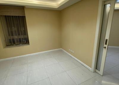 Empty interior room with tiled flooring and recessed lighting