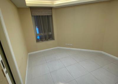 Empty bedroom with modern lighting and tiled flooring