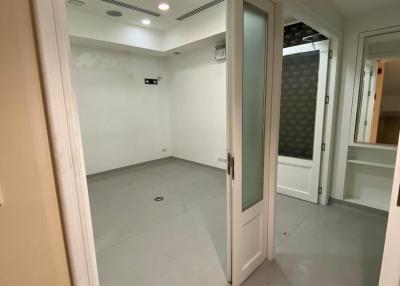 Empty room with tiled floor and recessed lighting