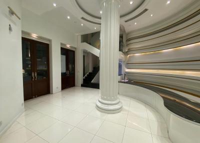 Spacious and modern lobby with elegant staircase and columns