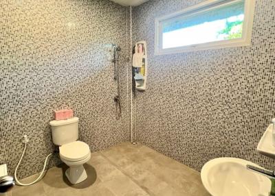 Modern bathroom with patterned wall tiles and walk-in shower