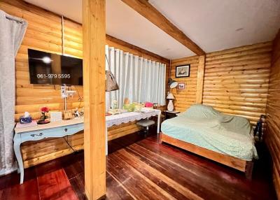 Cozy wooden cabin style bedroom with ample lighting