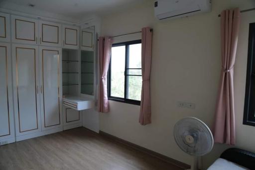 Cozy bedroom with built-in wardrobe and air conditioning unit