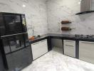 Modern kitchen interior with marble finish and built-in appliances
