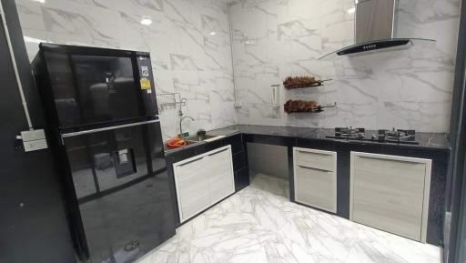 Modern kitchen interior with marble finish and built-in appliances