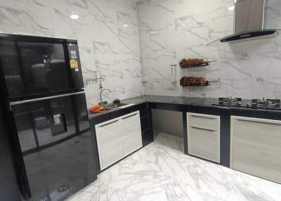 Modern kitchen interior with marble finish and built-in appliances