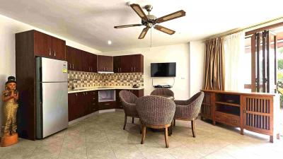 Spacious living room with kitchenette, dining area, and modern appliances