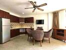 Spacious living room with kitchenette, dining area, and modern appliances