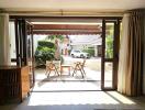 Spacious living room with large sliding doors leading to outdoor patio