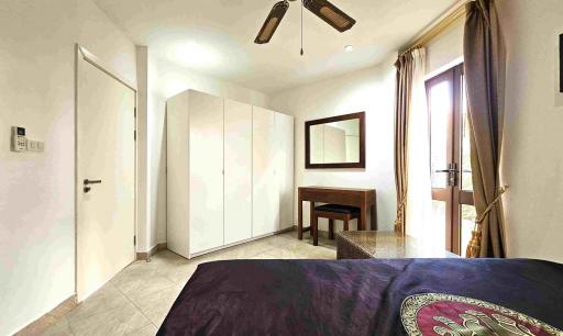 Spacious bedroom with large bed and wardrobe