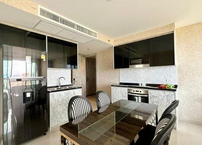 Modern kitchen with integrated appliances and dining area