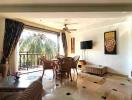 Spacious living room with balcony access and tropical view