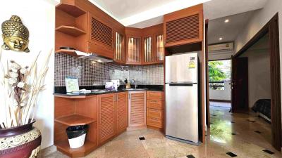 Modern kitchen with wooden cabinets and stainless steel appliances