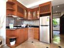 Modern kitchen with wooden cabinets and stainless steel appliances