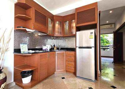 Modern kitchen with wooden cabinets and stainless steel appliances