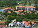 Aerial view of a resort complex with multiple condos, amenities, and proximity to the beach