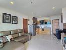 Open concept living room with kitchen in the background