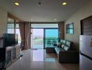 Spacious living room with balcony access and waterfront view