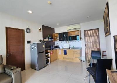Spacious combined living room and kitchen with modern appliances and comfortable seating