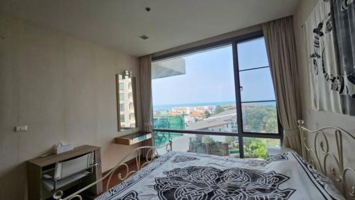 Bright bedroom with large window overlooking the sea