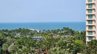 Picturesque ocean view from the balcony surrounded by lush greenery