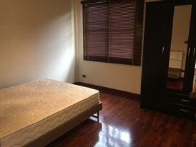 Cozy bedroom with natural light and hardwood floors