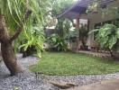 Cozy backyard with lush greenery and covered patio