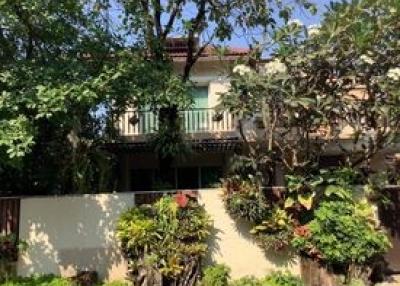 Cozy suburban house with a lush garden and balcony