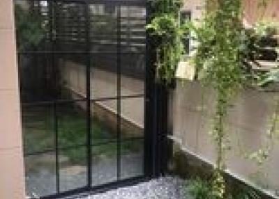Tranquil outdoor patio area with garden and secure glass fencing