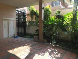 Shaded outdoor patio area with greenery