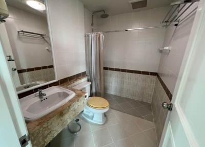 Bright bathroom with full bathtub and tile flooring