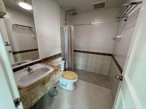 Bright bathroom with full bathtub and tile flooring