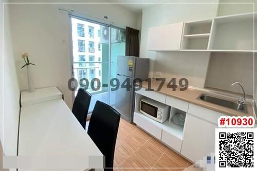 Modern compact kitchen with white cabinetry and dining area